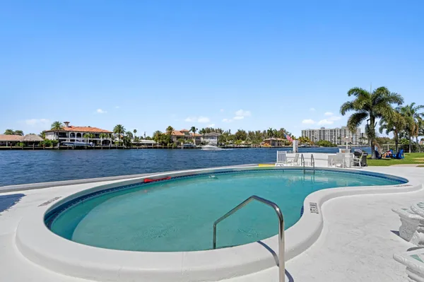 a view of a swimming pool with a yard