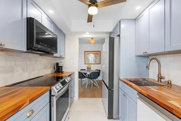 a kitchen that has a sink and a stove top oven