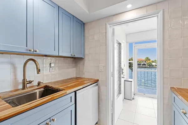 a view of a kitchen with a sink and cabinets