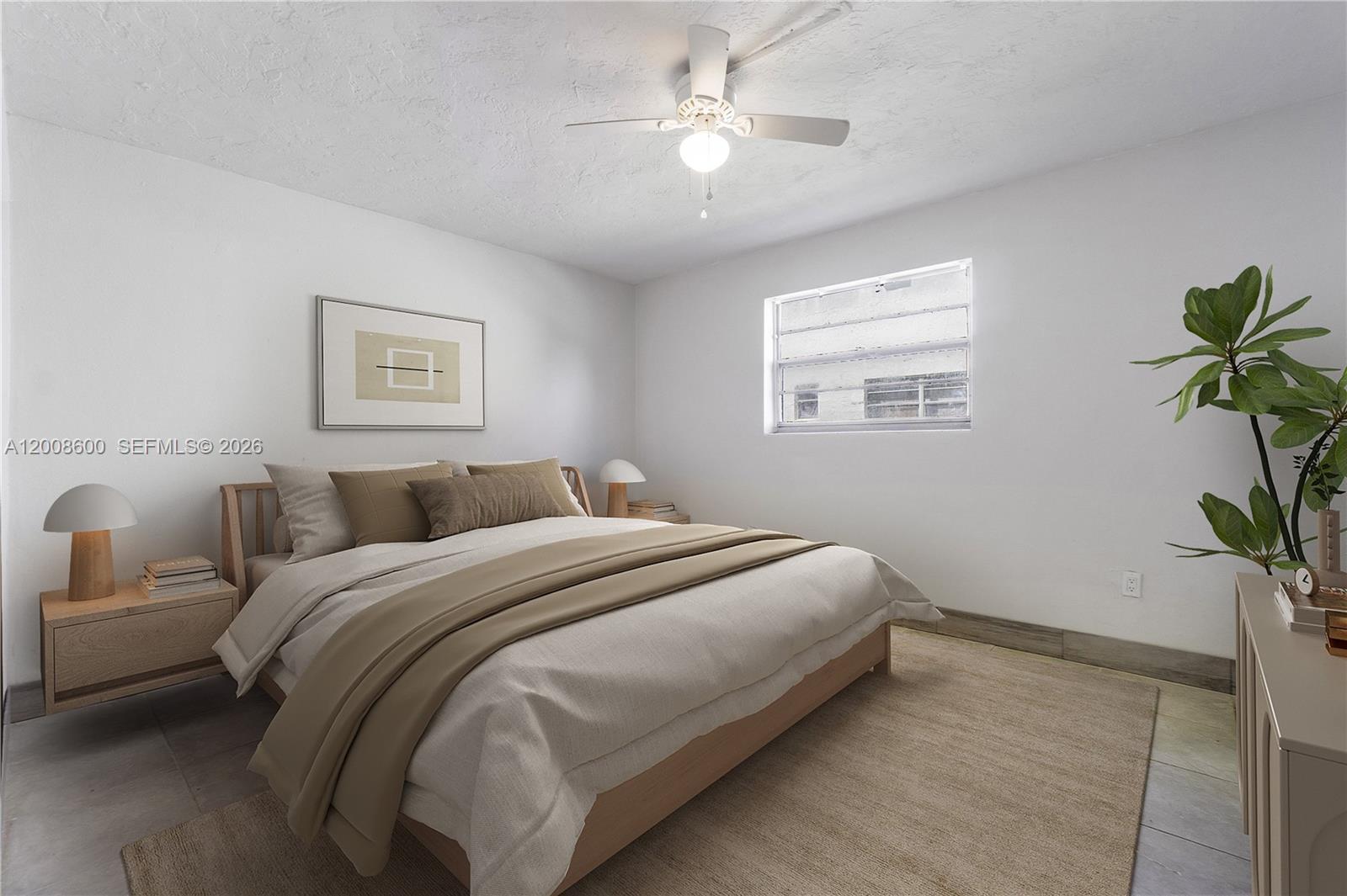 332 Southwest 3rd Street, Unit 2 Belle Glade, FL 33430 - Photo 3 of 7 a spacious bedroom with a bed and a potted plant