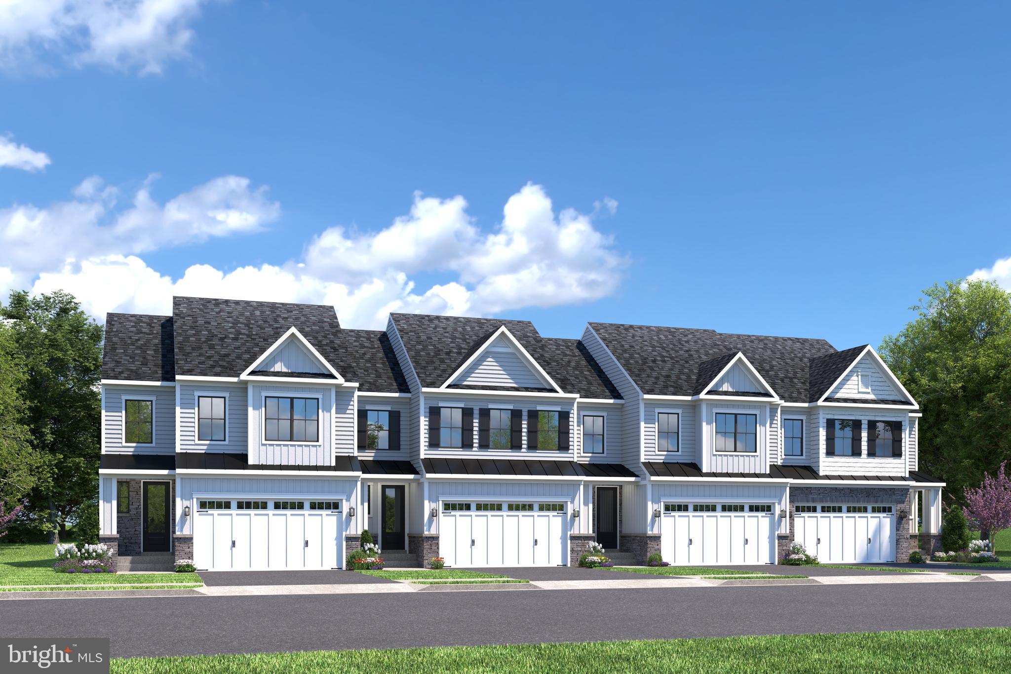 a view of house with a big yard and large trees