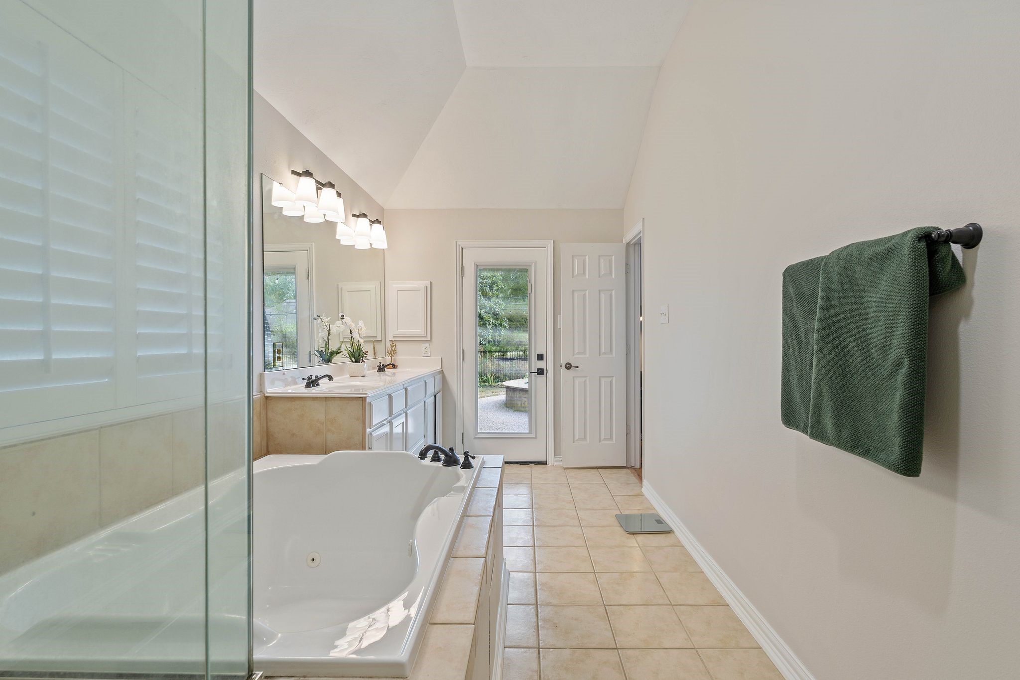 2408 Hollowbrook Lane Conroe, TX 77384 - Photo 23 of 49 Primary bathroom with exit door leading to the back yard and spa.