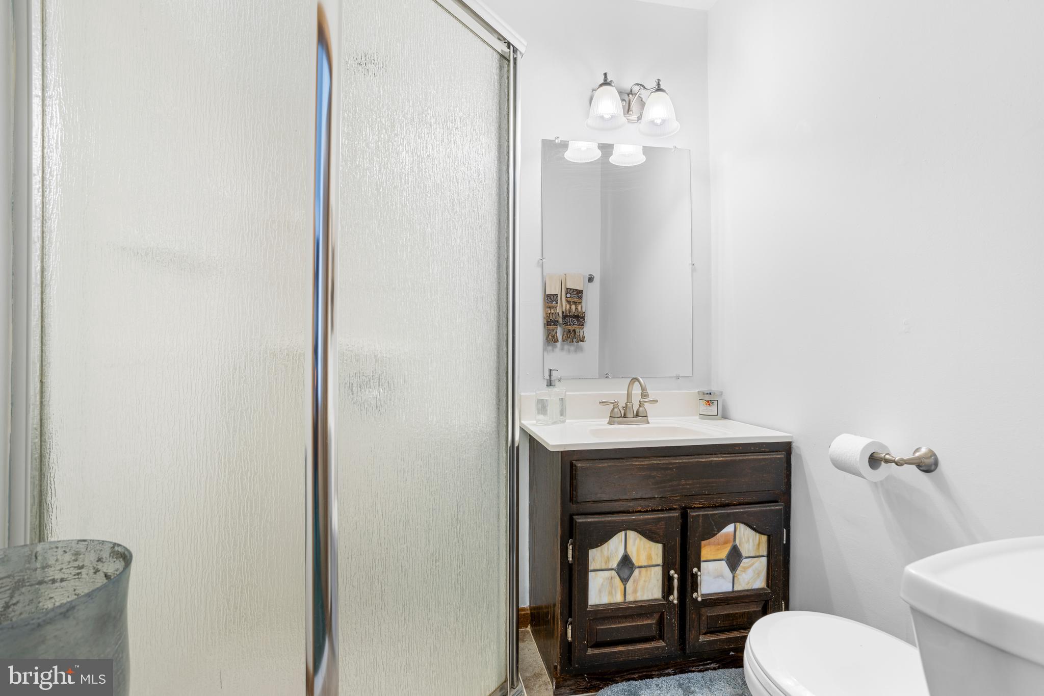 351 Shaw Road Ridley Park, PA 19078 - Photo 17 of 33 a bathroom with a toilet a sink and mirror