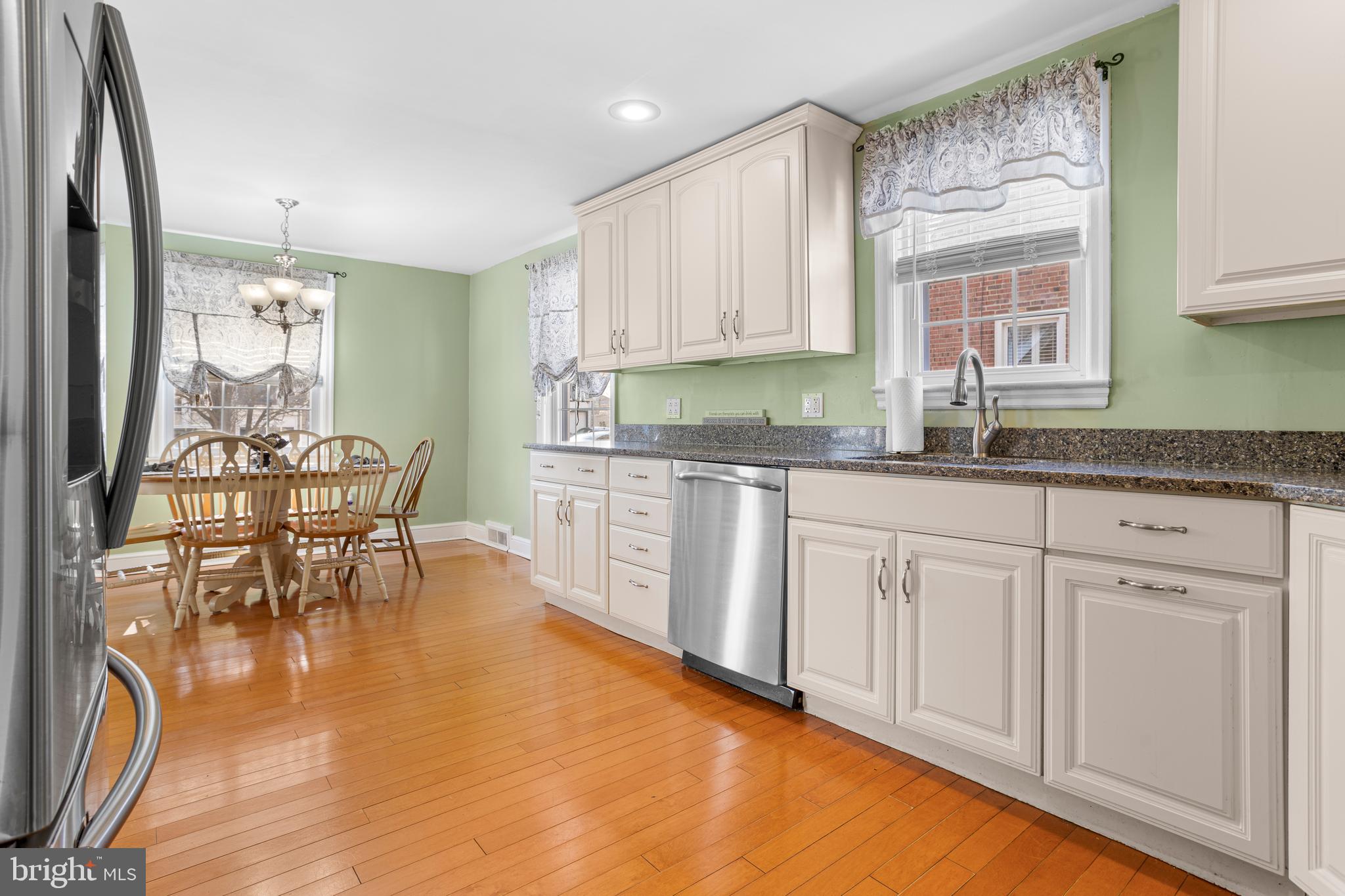 351 Shaw Road Ridley Park, PA 19078 - Photo 9 of 33 a kitchen with stainless steel appliances granite countertop a table chairs sink and cabinets