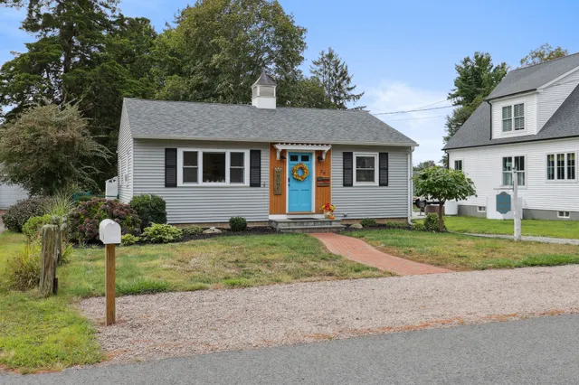 a front view of house with yard and green space