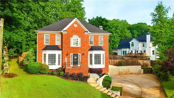 a front view of a house with a yard
