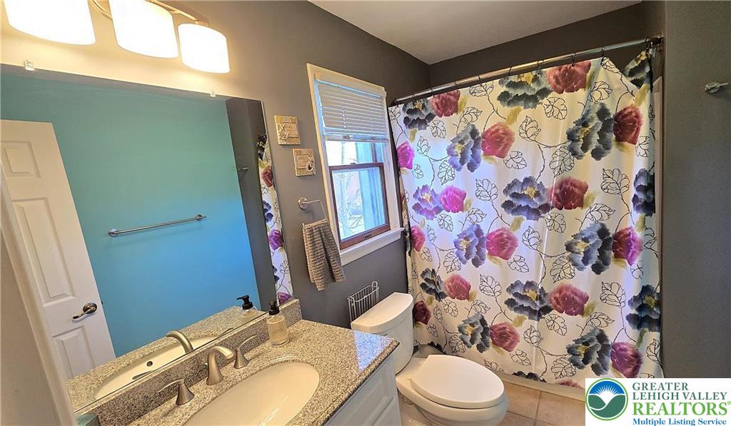 194 Springhouse Road Allentown, PA 18104 - Photo 21 of 34 This bright bathroom features a spacious vanity and a well-lit mirror, perfect for daily routines.