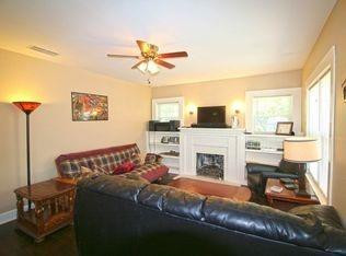 1910 16th Street Lubbock, TX 79401 - Photo 3 of 21 a living room with furniture a fireplace and a flat screen tv