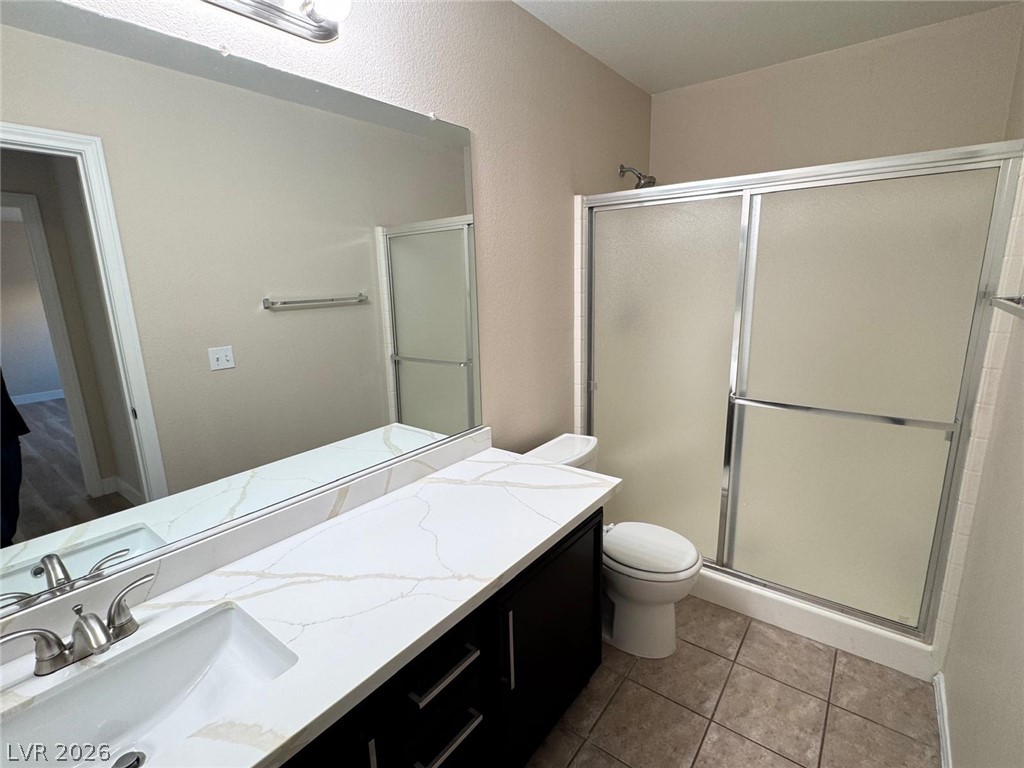 3962 Coyote Ridge Court Las Vegas, NV 89129 - Photo 33 of 35 Modern bath with pristine countertops and a sleek shower enclosure.