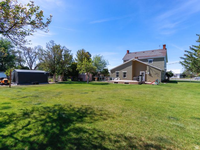 155 West Center Street Fillmore, UT 84631 - Photo 72 of 86 Expansive green lawn with a two-story residence featuring a wood deck and a dedicated outbuilding