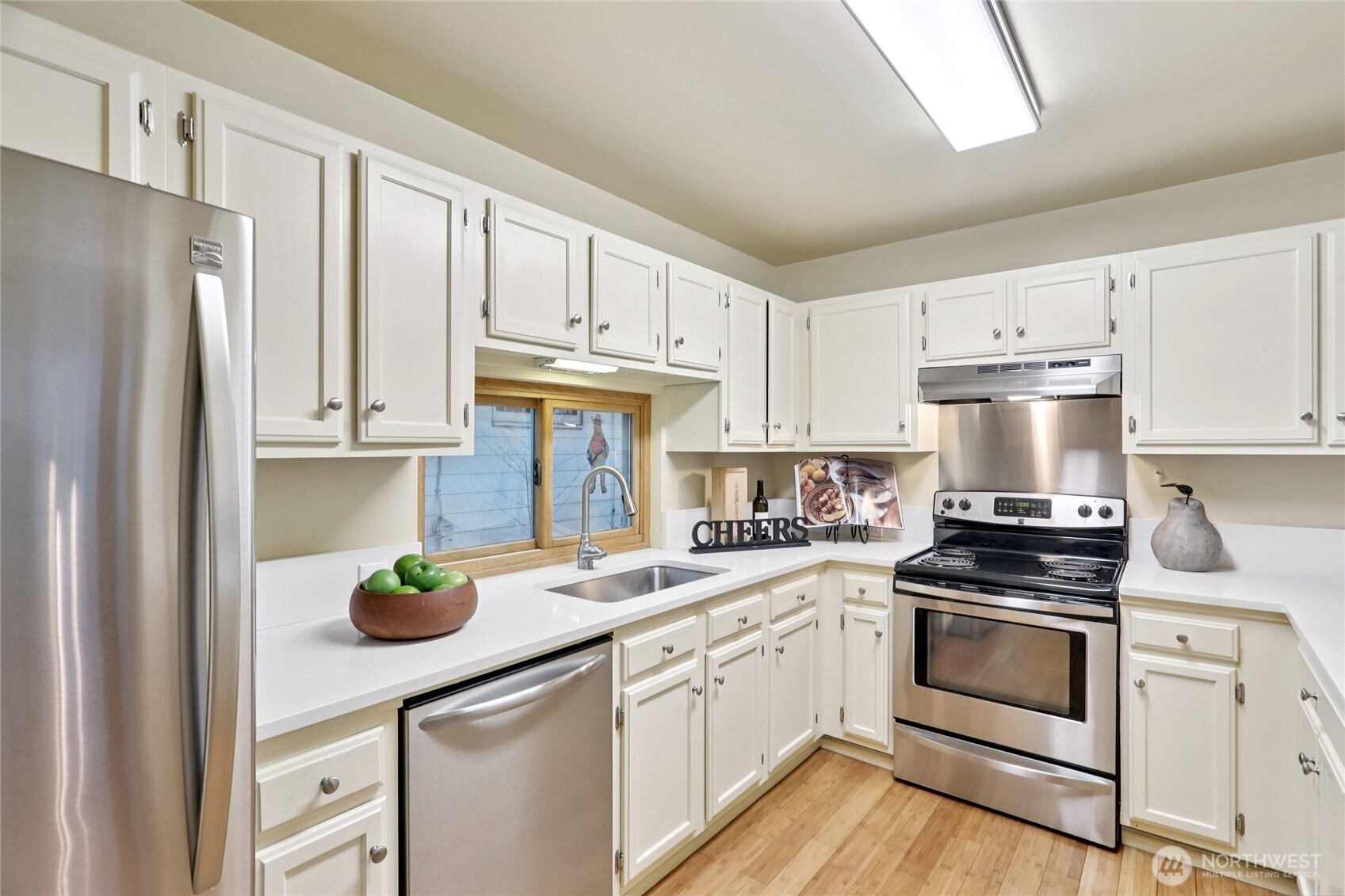 8207 Meridian Avenue North Seattle, WA 98103 - Photo 12 of 34 a kitchen with cabinets stainless steel appliances and wooden floor