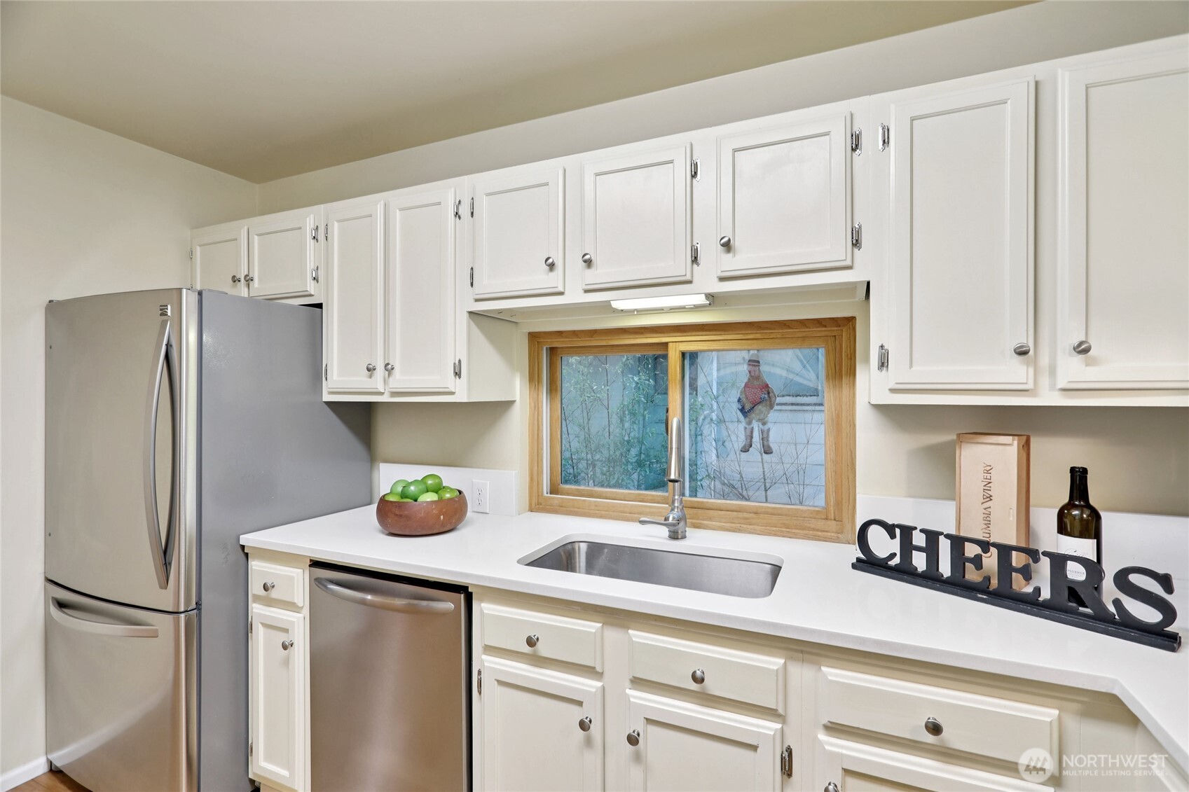 8207 Meridian Avenue North Seattle, WA 98103 - Photo 13 of 34 a kitchen with stainless steel appliances granite countertop a refrigerator and white cabinets
