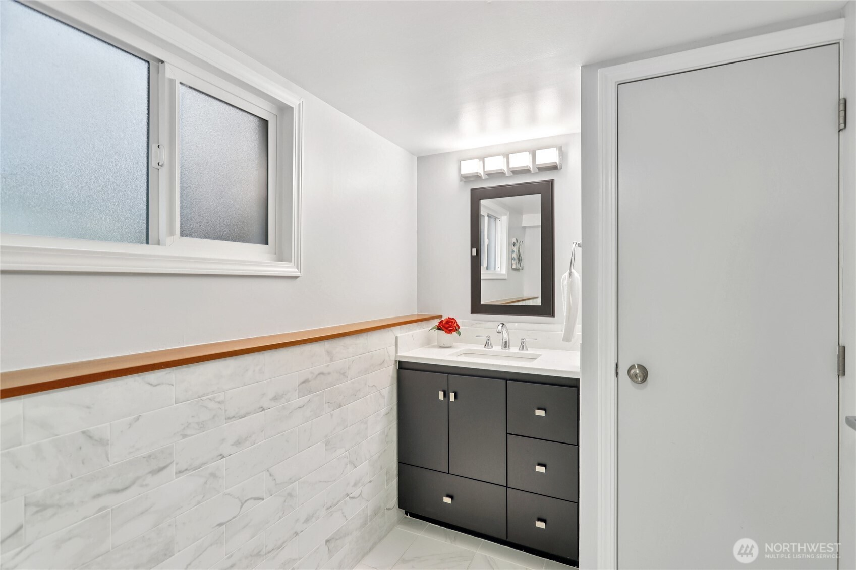 8207 Meridian Avenue North Seattle, WA 98103 - Photo 16 of 34 a bathroom with a toilet sink and mirror