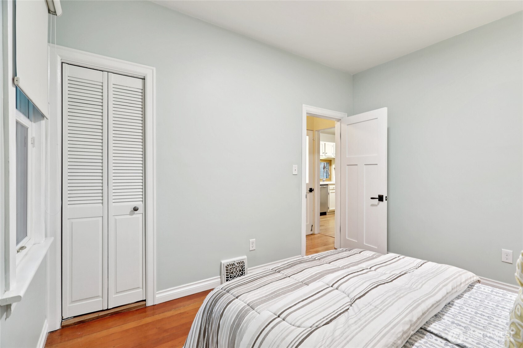 8207 Meridian Avenue North Seattle, WA 98103 - Photo 26 of 34 a bedroom with a bed and wooden floor