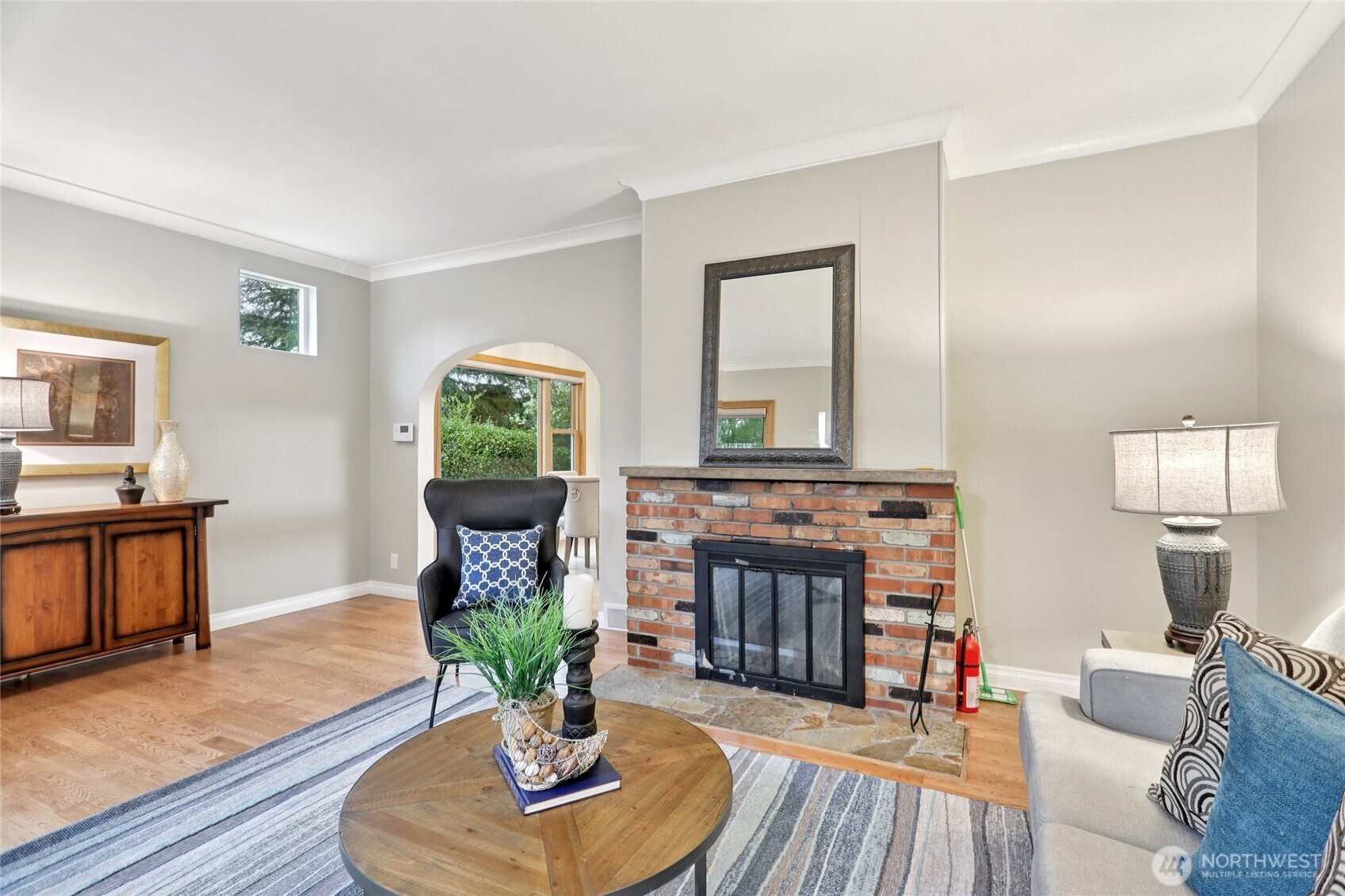 8207 Meridian Avenue North Seattle, WA 98103 - Photo 6 of 34 a living room with furniture a fireplace and a table