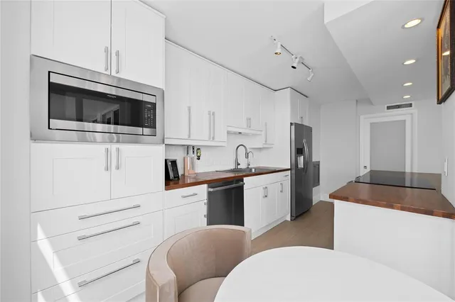 a bed sitting in a bedroom next to a window with potted plant