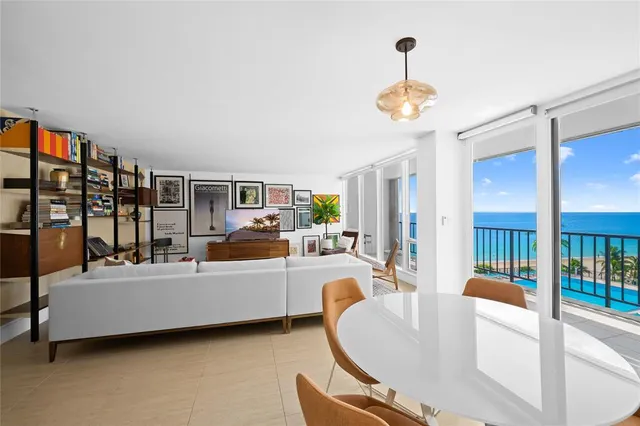 a living room with furniture a chandelier and a window