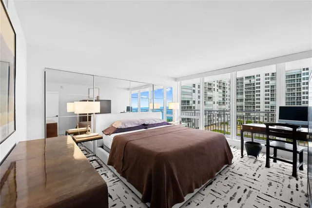 a living room with furniture and a wall painting