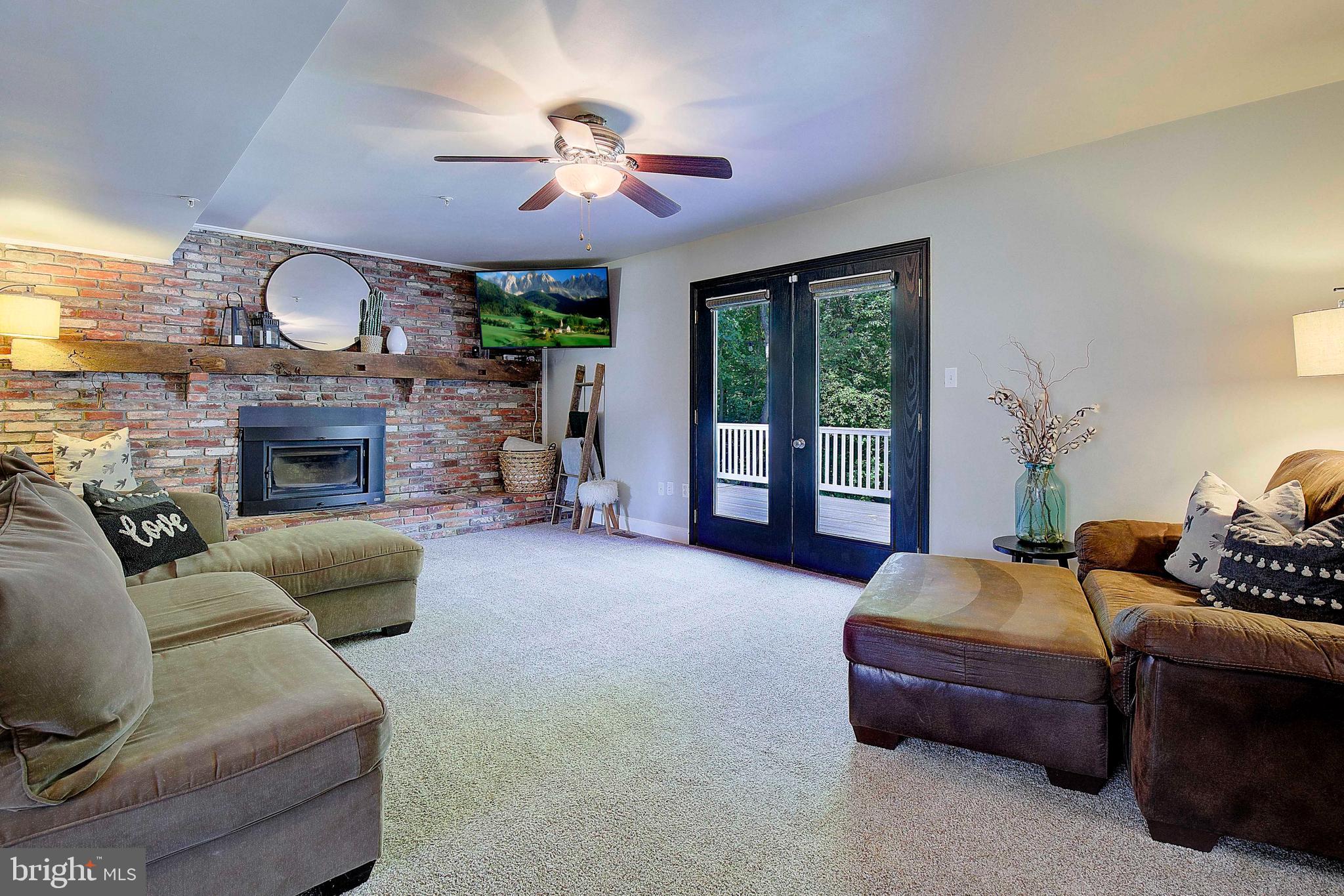 7006 Prout Road Friendship, MD 20758 - Photo 12 of 48 a living room with furniture a fireplace and a flat screen tv