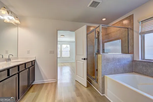 a bathroom with a sink a mirror and a bathtub