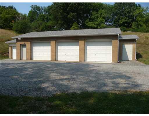 393 Kaufman Road Tarentum, PA 15084 - Photo 6 of 23 Other. Front view of 4 garages and 2 storage units that are located at the end of the driveway/parking area. Each unit could be rented out for additional income on property.