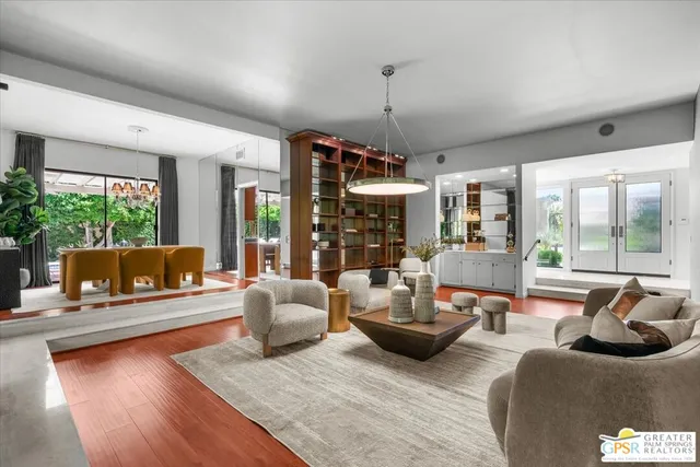 a living room with fireplace furniture and a large window