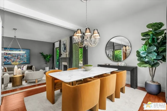 a dining room with furniture potted plants and wooden floor