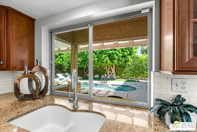 a large kitchen with stainless steel appliances granite countertop lots of counter top space