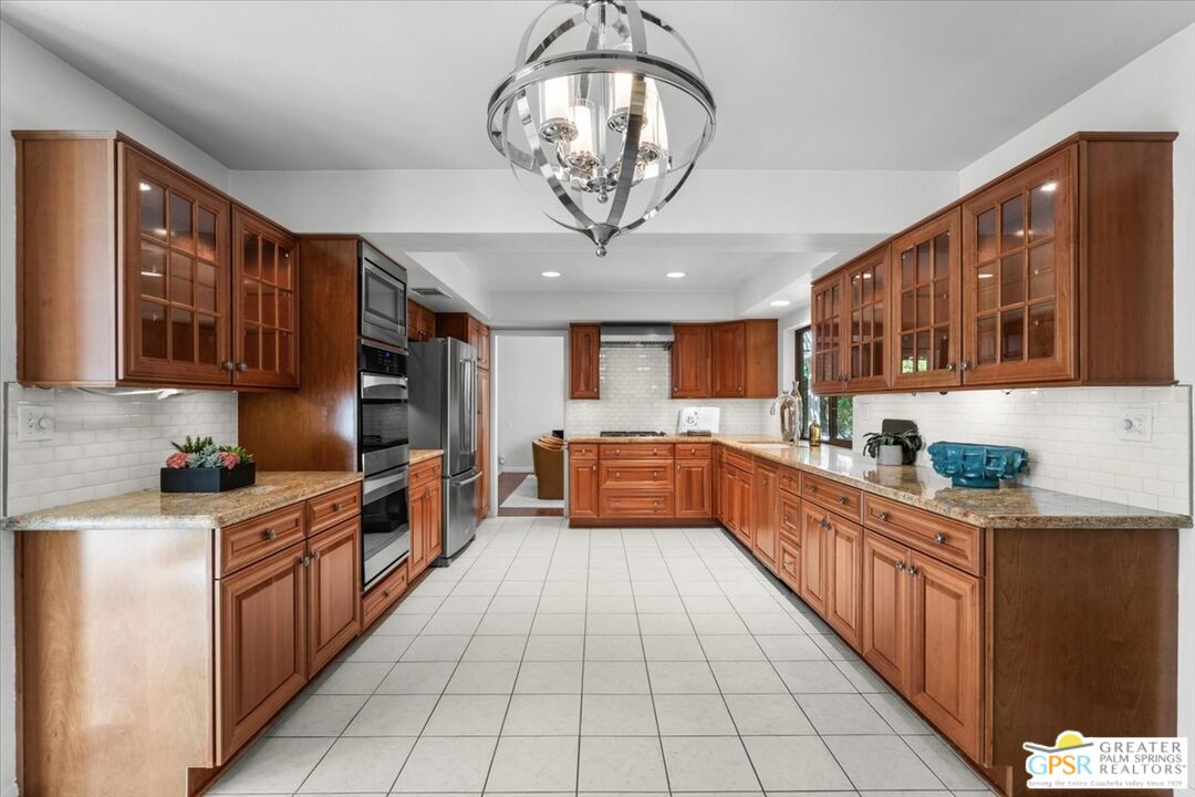 55 Sierra Madre Street Rancho Mirage, CA 92270 - Photo 15 of 59 a large kitchen with stainless steel appliances granite countertop lots of counter top space