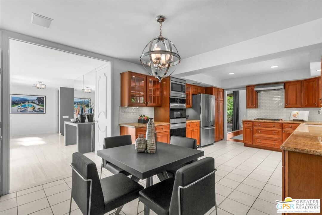 55 Sierra Madre Street Rancho Mirage, CA 92270 - Photo 17 of 59 a view of a dining room with furniture a chandelier and wooden floor