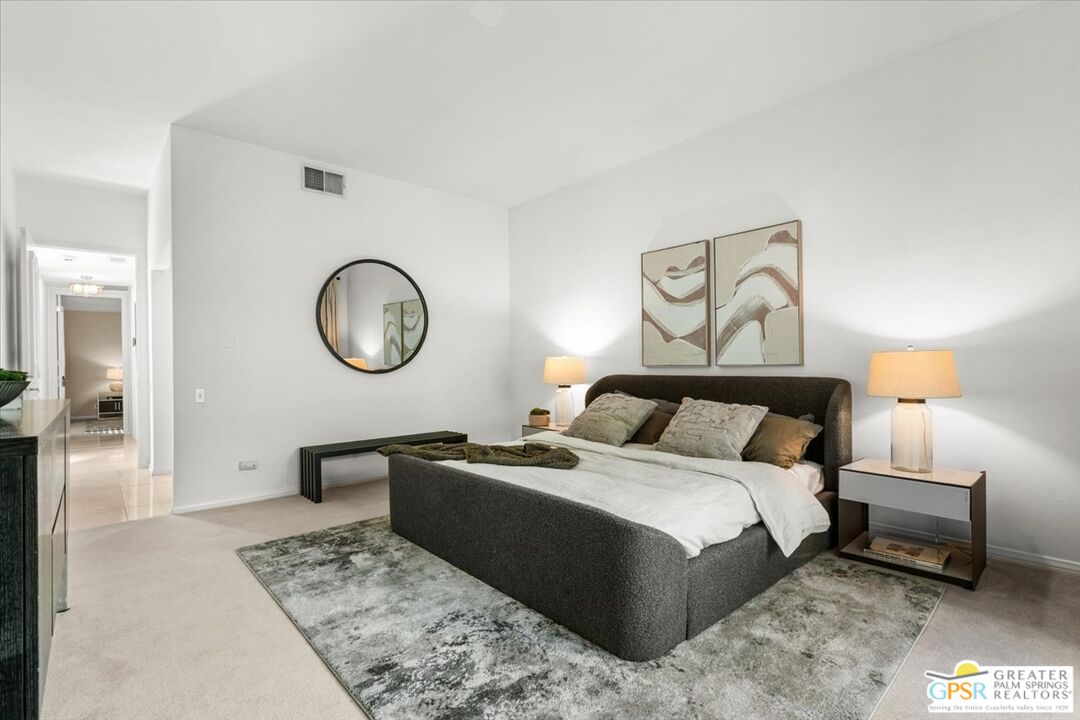 55 Sierra Madre Street Rancho Mirage, CA 92270 - Photo 20 of 59 a bedroom with a bed a mirror and a lamp on table