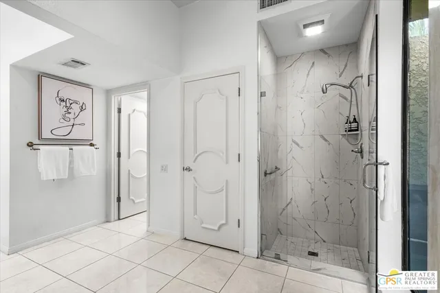 a bedroom with a large bed and a large window