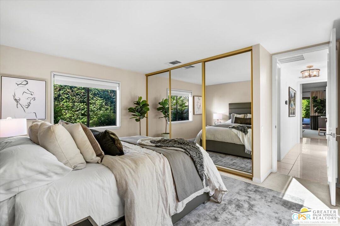 55 Sierra Madre Street Rancho Mirage, CA 92270 - Photo 27 of 59 a bedroom with a large bed and a large window