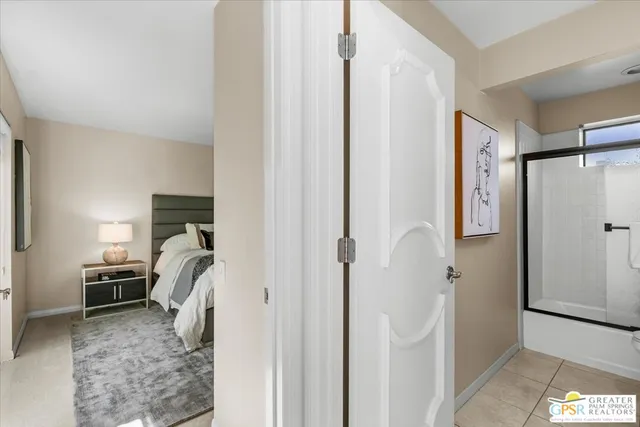 a living room with furniture a mirror and a large window