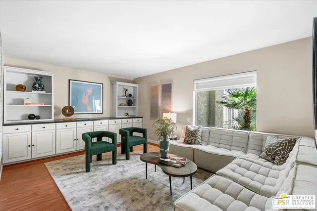 a view of a patio with a dining table and chairs with wooden floor