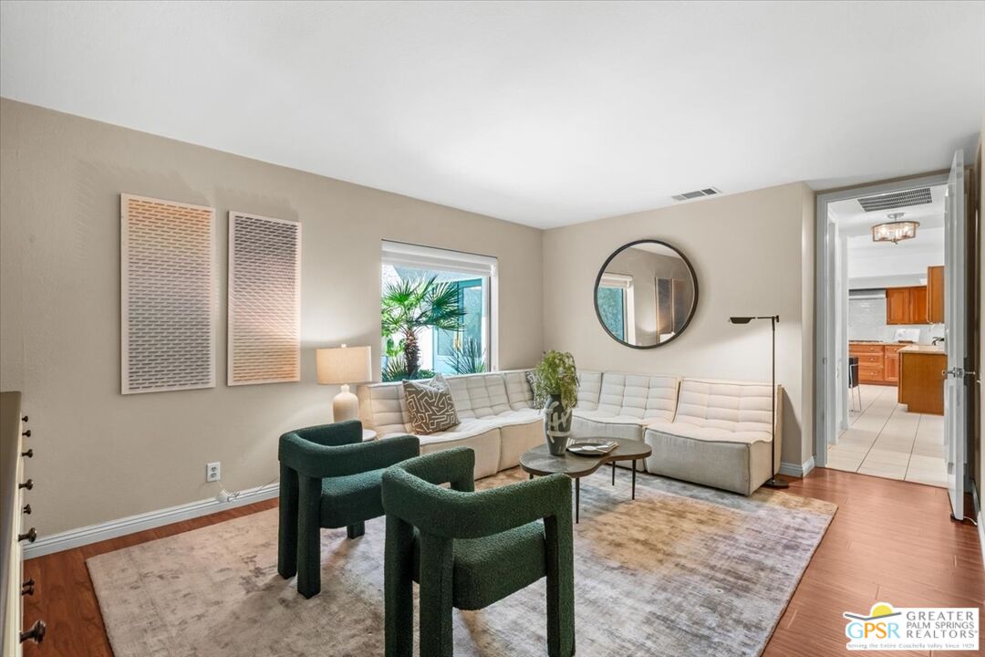 55 Sierra Madre Street Rancho Mirage, CA 92270 - Photo 32 of 59 a living room with furniture a mirror and a large window