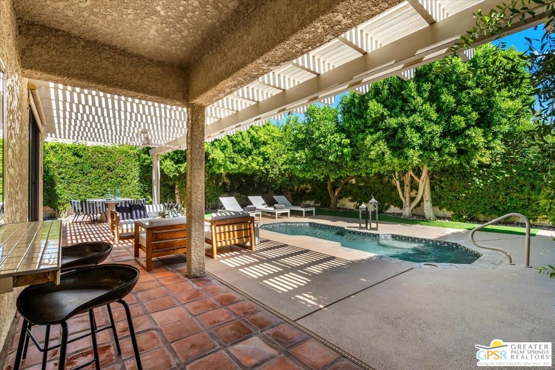 55 Sierra Madre Street Rancho Mirage, CA 92270 - Photo 35 of 59 a view of a patio with a dining table and chairs with wooden floor