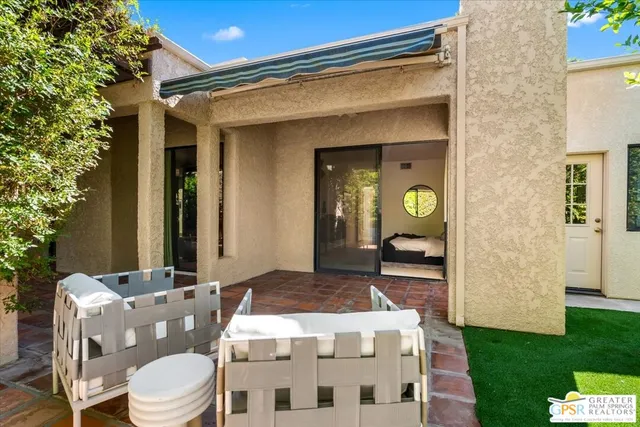a view of a patio with table and chairs and potted plants