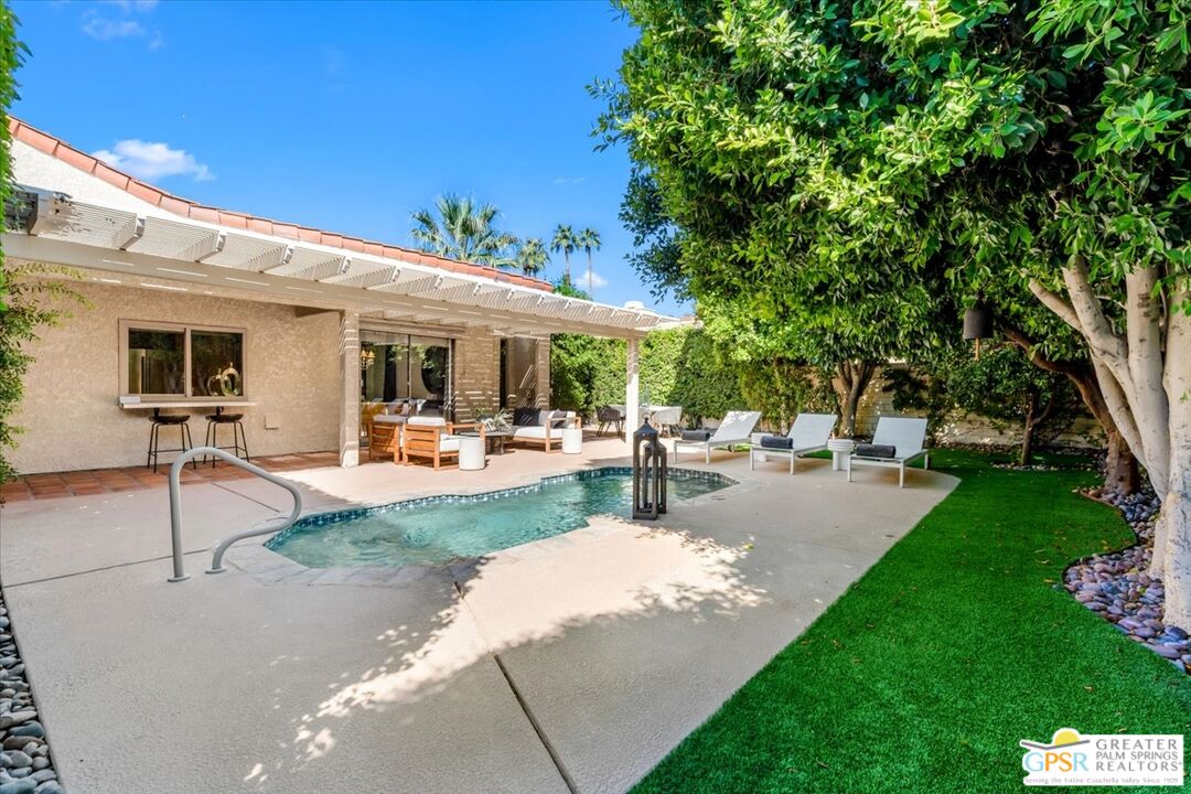 55 Sierra Madre Street Rancho Mirage, CA 92270 - Photo 42 of 59 a view of a patio with a table and chairs under an umbrella