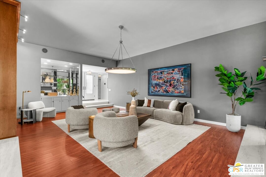 55 Sierra Madre Street Rancho Mirage, CA 92270 - Photo 8 of 59 a living room with furniture a chandelier and a wooden floor