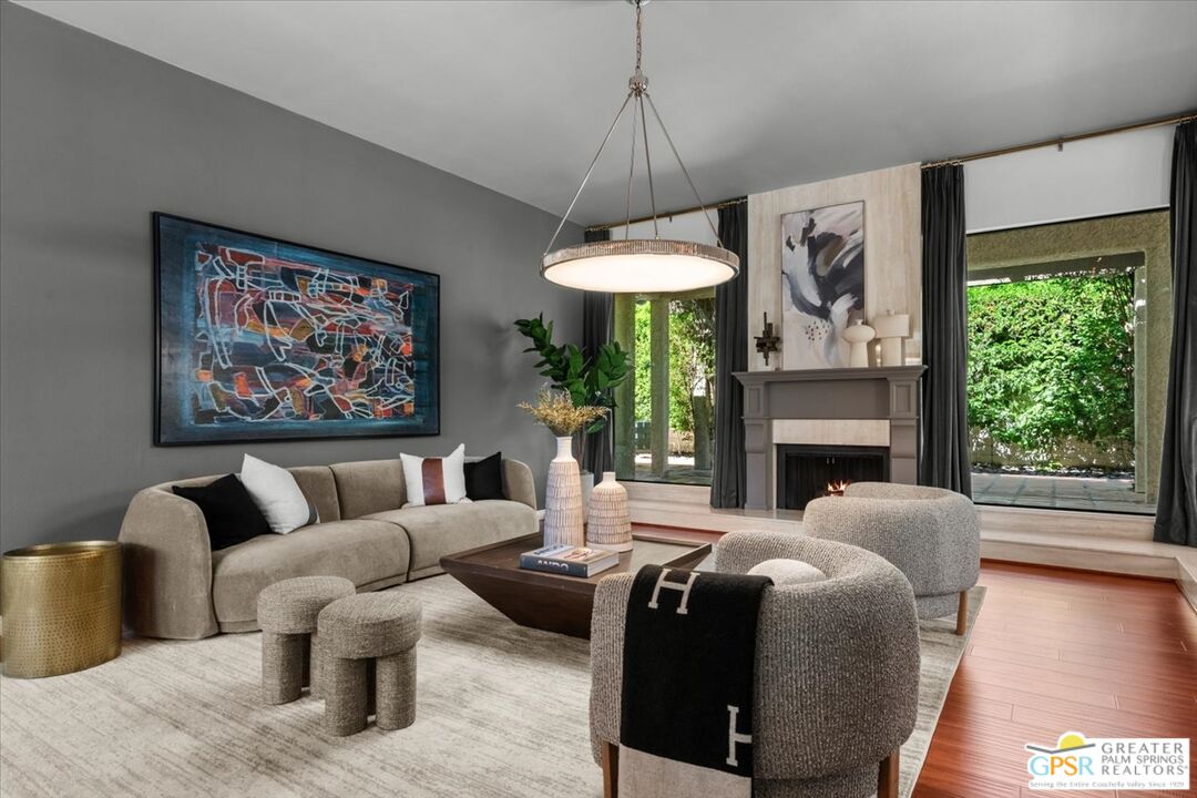 55 Sierra Madre Street Rancho Mirage, CA 92270 - Photo 9 of 59 a living room with furniture a lamp and a fireplace