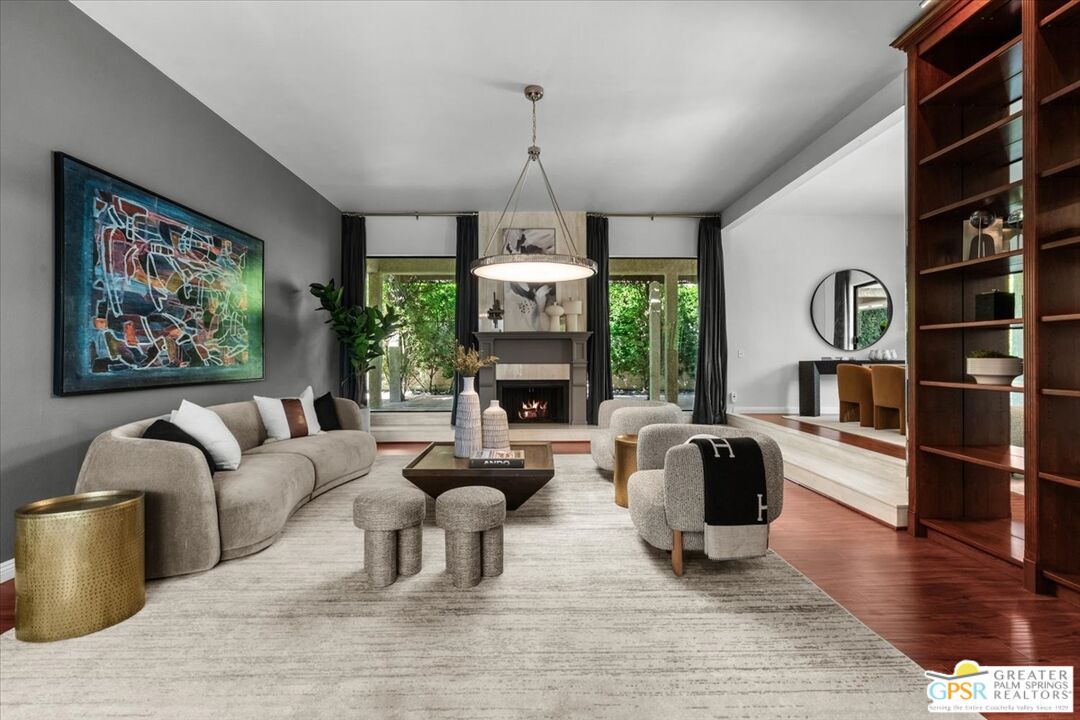 55 Sierra Madre Street Rancho Mirage, CA 92270 - Photo 10 of 59 a living room with furniture a fireplace and a chandelier