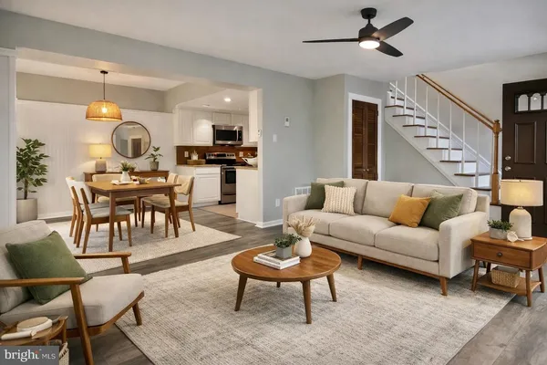 a living room with furniture a rug and a chandelier