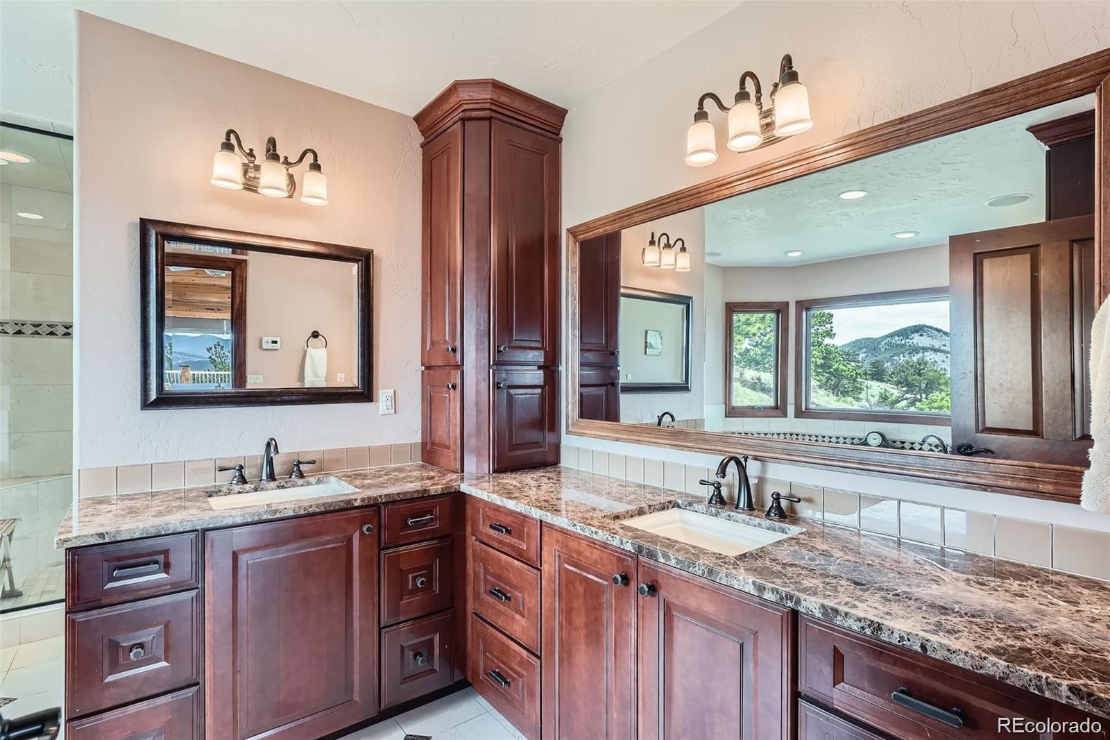 401 Raptor Point Golden, CO 80403 - Photo 12 of 40 a bathroom with a granite countertop double vanity sink and a window