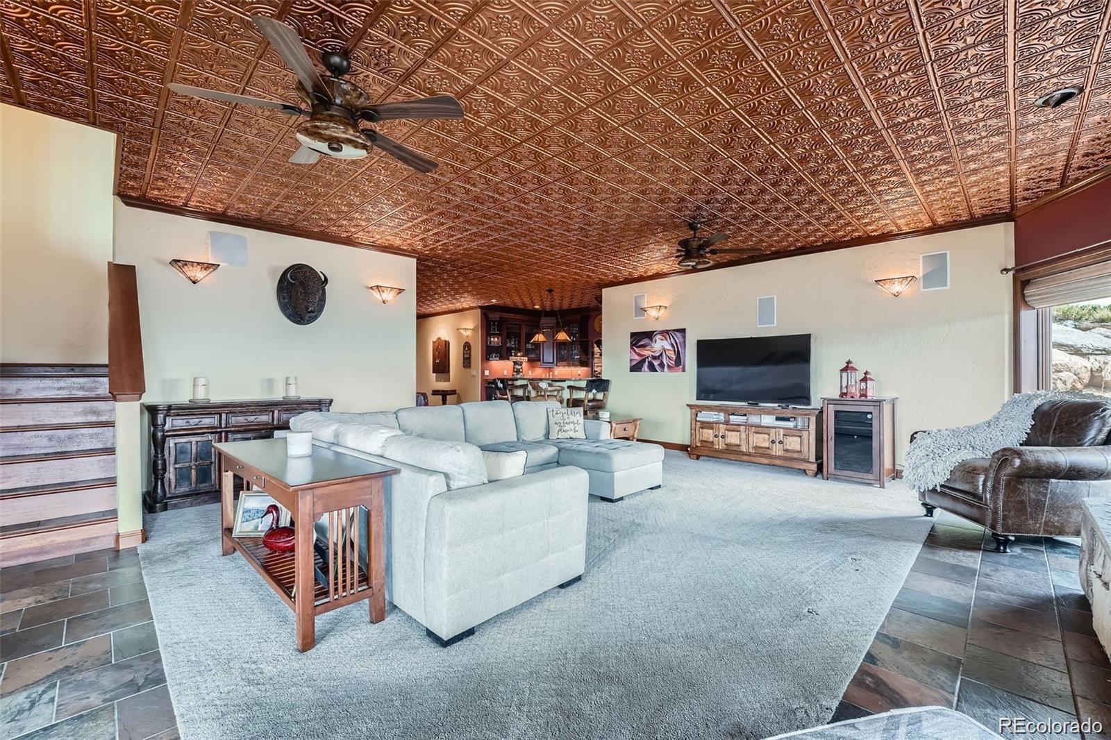 401 Raptor Point Golden, CO 80403 - Photo 15 of 40 a living room with furniture and a flat screen tv