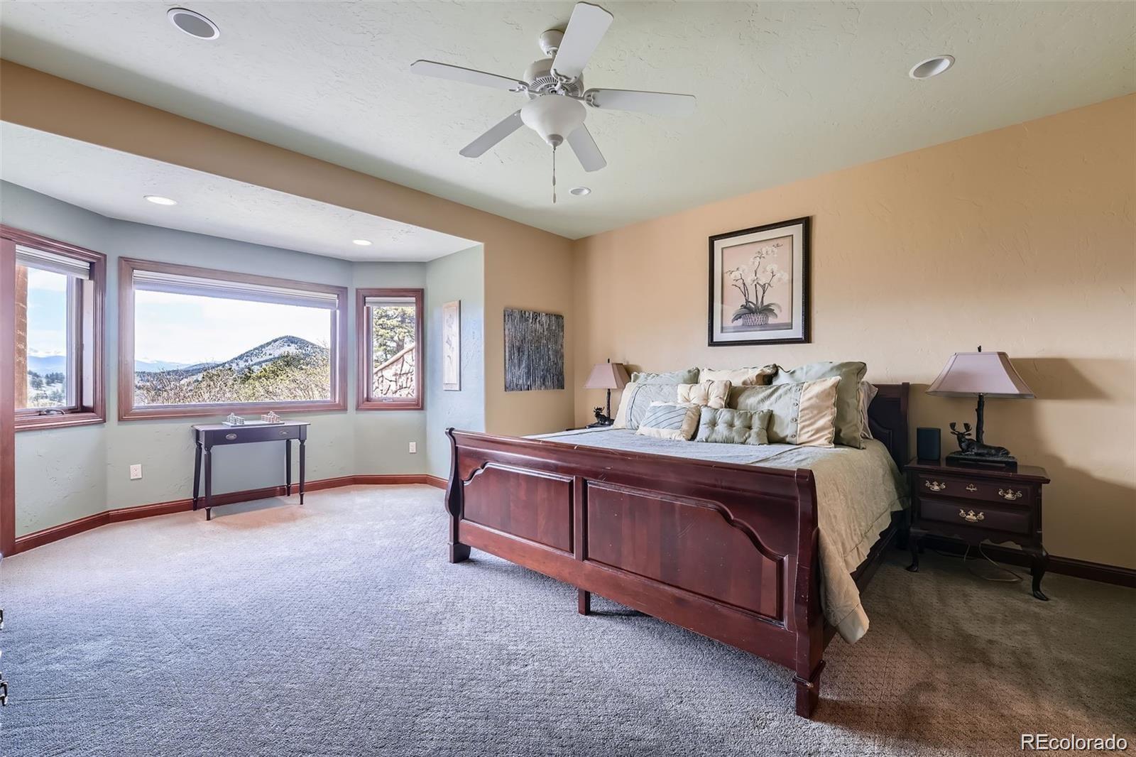 401 Raptor Point Golden, CO 80403 - Photo 16 of 40 a spacious bedroom with a bed and a window