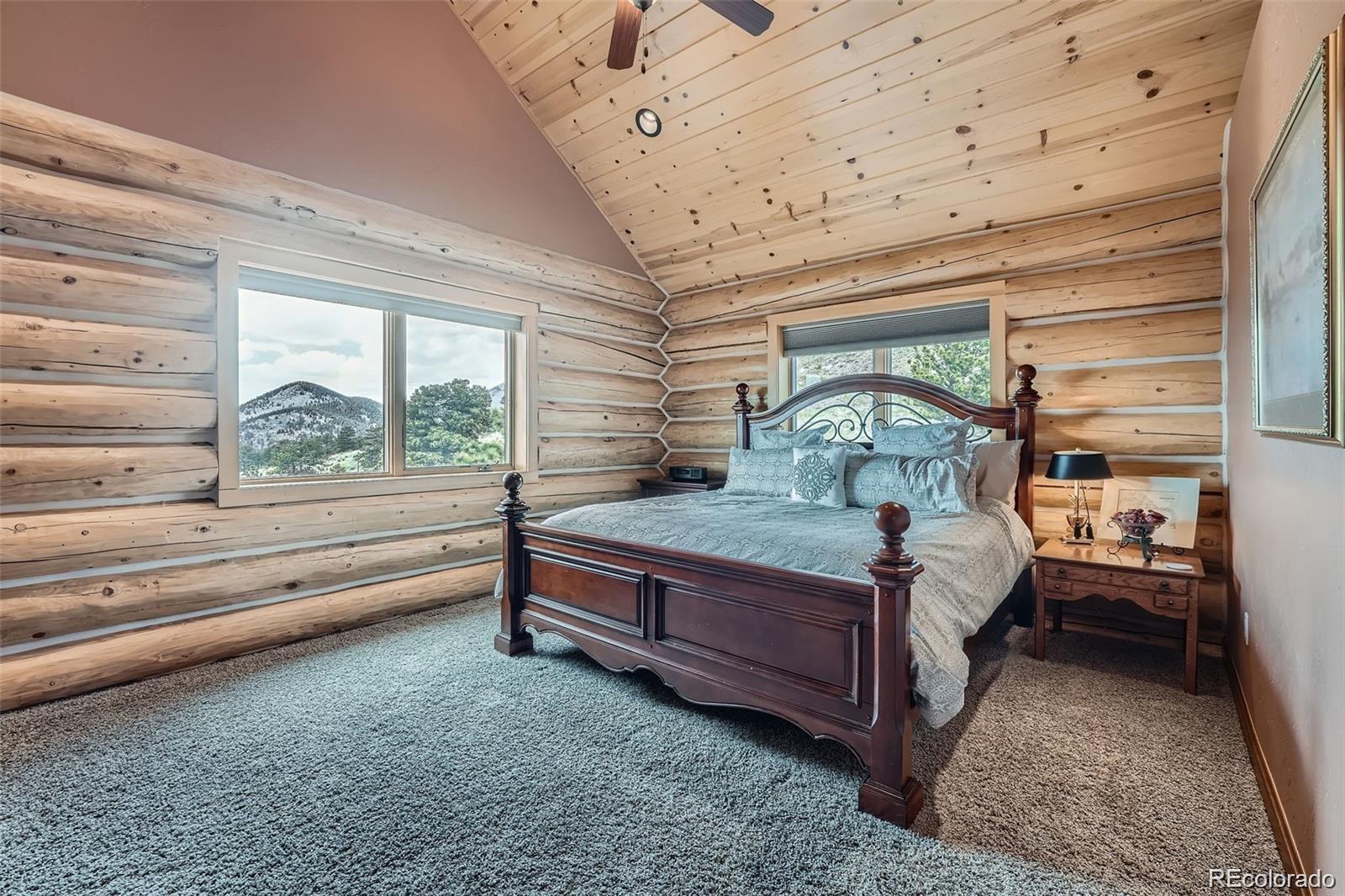401 Raptor Point Golden, CO 80403 - Photo 18 of 40 a bedroom with a bed and large window