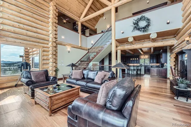 a kitchen with stainless steel appliances kitchen island granite countertop a table chairs microwave and stove top oven