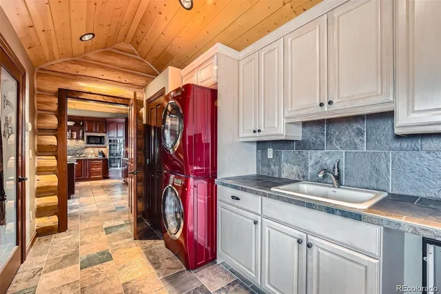 a kitchen with lots of wooden cabinets appliances and furniture