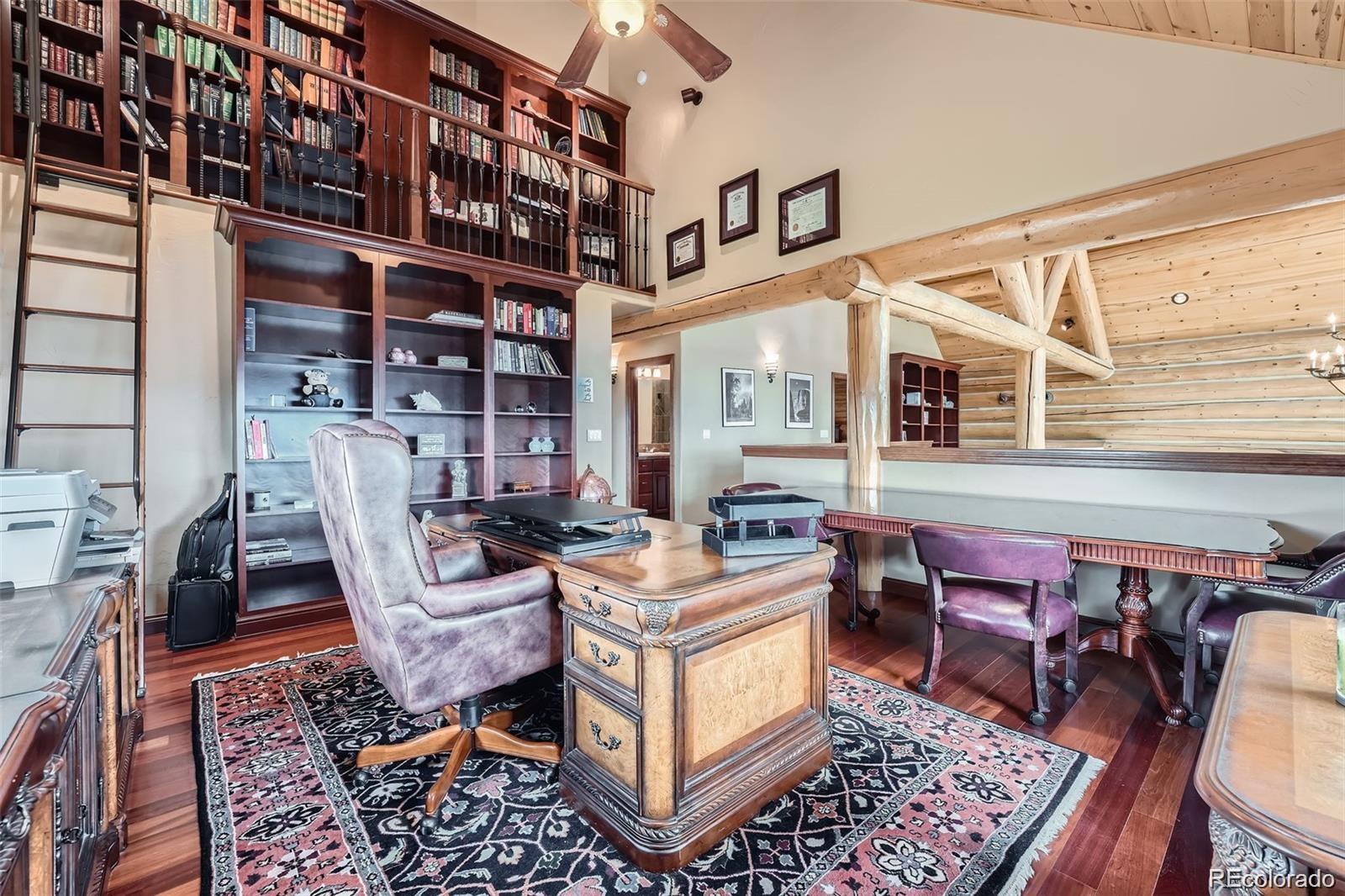 401 Raptor Point Golden, CO 80403 - Photo 6 of 40 a living room with furniture a rug and a bookshelf